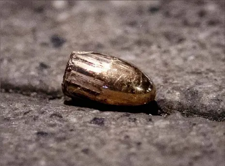  ?? Michael Probst/Associated Press ?? A projectile lies on the sidewalk on Thursday near a restaurant at the scene of a shooting on Wednesday night in central Hanau, Germany.