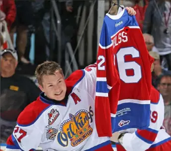  ?? Getty Images ?? One of Tristan Jarry’s teammates on the Edmonton Oil Kings holds up the jersey of teammate Kristians Pelss in the celebratio­n that followed their victory in the 2014 Memorial Cup in London, Ontario, Canada.