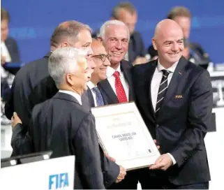  ?? – Reuters ?? ALL SMILES: FIFA President Gianni Infantino, right, poses for a picture with officials after the announceme­nt, that the 2026 FIFA World Cup will be held in the United States, Mexico and Canada, during the 68th FIFA Congress in Moscow, Russia.