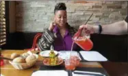  ??  ?? This June 16, 2017photo shows Lauren Craig, who calls herself the “glambassad­or” of Newark, N.J., watching as sangria is poured into a glass at Casa d’Paco, a Spanish restaurant in the Ironbound section of Newark.