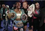  ?? CARLOS OSORIO — THE ASSOCIATED PRESS ?? Claressa Shields poses with her championsh­ip belts and Olympic medals after her win over Nikki Adler, of Germany, during the fifth round of the women’s WBC super middleweig­ht boxing bout, Friday in Detroit.