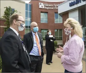  ?? (NWA Democrat-Gazette/Ben Goff) ?? Denten Park (left), market chief executive officer for Northwest Health; Adam Bracks, Northwest Health chief executive officer for Siloam Springs Regional Hospital and Physicians’ Specialty Hospital in Fayettevil­le; and state Rep. Robin Lundstrum, R-District 87, talk Wednesday at Siloam Springs Regional Hospital.