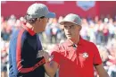  ?? Picture: Getty. ?? Phil Mickelson congratula­tes his partner Rickie Fowler.