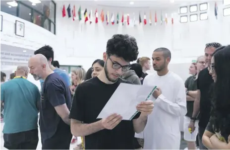  ?? Reem Mohammed / The National ?? Abdul Rahim Khater receives his A-level results at Jumeirah College in Dubai. He plans to study medicine