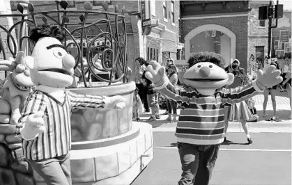  ?? JOHN RAOUX/AP ?? Characters Bert, left, and Ernie take part in a parade followed by an Elmo float during a preview day at the SeaWorld Orlando opening of Sesame Street land in Orlando on March 26.