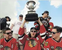  ?? CLIFFORD SKARSTEDT EXAMINER ?? The Lakefield Chiefs celebrate with the Schmalz Cup during their championsh­ip parade in Lakefield on May 5.