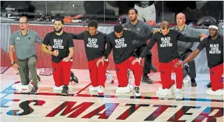 ?? KIM KLEMENT THE ASSOCIATED PRESS FILE PHOTO ?? The Toronto Raptors kneel during the national anthem before Game 3 of an NBA first-round playoff series in August. It was one of many images of athlete activism during 2020.
