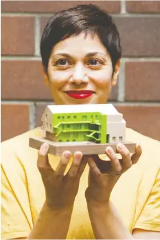  ?? GERRY KAHRMANN / PNG ?? Marianne Amodio, an architect with MA + HG architects in Vancouver, holds a model of family-friendly Tomo House she is designing.