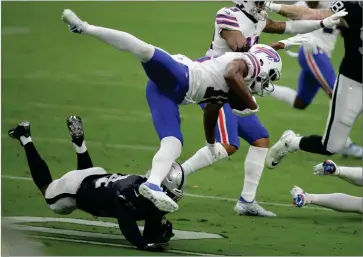  ?? AP PHOTO BY ISAAC BREKKEN ?? Las Vegas Raiders strong safety Johnathan Abram (24) tackles Buffalo Bills wide receiver Andre Roberts (18) during the first half of an NFL football game, Sunday, Oct. 4, in Las Vegas.