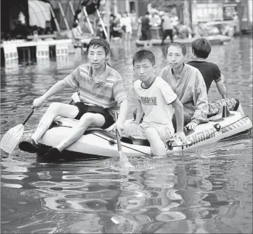  ?? Photograph­s by European Pressphoto Agency ?? IN SHENYANG, people get around by raft this month after the worst flooding in years in northern China.