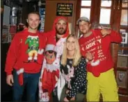  ?? NICHOLAS BUONANNO- NBUONANNO@TROYRECORD.COM ?? Some friends enjoy the start of the 11th annual Ugly Sweater Pub Crawl in Saratoga Saturday, from left, Connor Potvin, Joe Naylor, Maddy Wheeler and Carvey Iannuzzi.