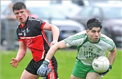 ??  ?? Shane O’Grady of Eastern Harps in action with Drumcliffe/Rosses Point’s Stephen Regan in Fr Kevin Brehony Park. Pics: Tom Callanan.