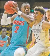  ?? SHANNON BRODERICK/LARAMIE BOOMERANG VIA AP ?? UNM guard Sam Logwood, left, against Wyoming on Feb. 20. The senior who wanted to quit the team, and did at one point, has rebounded since his return to the lineup.