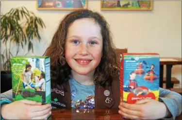  ?? PHOTO BY EMILY RYAN ?? Get your Girl Scout cookies while they last! Second grader McKenna Lausch shows off some favorites.