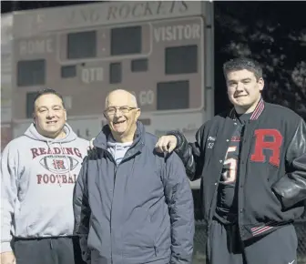  ?? NICOLAUS CZARNECKI / BOSTON HERALD ?? TIES THAT BIND: Reading senior Tyler Perillo (right) has learned a lot about football and family from his dad Rich (left) and grandfathe­r Al (center).