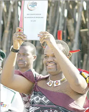  ?? ( File pic) ?? His Majesty King iii holding the Constituti­on of Eswatini.