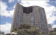  ??  ?? The Marco Polo building is shown on Saturday after a fire gutted several of the top floors of the residentia­l complex on Friday in Honolulu.