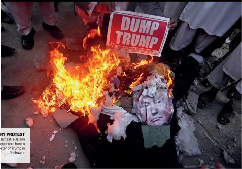  ??  ?? FIERY PROTEST Jamaat-e-Islami supporters burn a poster of Trump in Peshawar