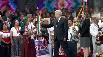  ??  ?? Obrador receives the staff of command from indigenous people at the AMLO Fest at Zocalo square in Mexico City. — Reuters photo