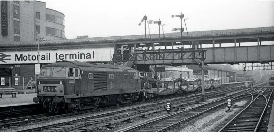  ??  ?? Kensington Olympia became the main hub for car-carrying services with the launch of the Motorail brand in 1966. Two years later on January 17, 1968 ‘Hymek' No. D7009 shunts a single Cartic-4 at the London terminal. Larger vehicles had to be carried in the middle well of the upper deck of these wagons. DC Collection