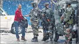  ??  ?? Army personnel frisk a man near the site of gunbattle at Karan Nagar, in Srinagar on Monday