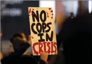  ?? KYLE ROBERTSON /THE COLUMBUS DISPATCH VIA AP ?? Protesters march up North Front Street, demonstrat­ing against Monday’s fatal shooting of a Black man in downtown Columbus, on April 13.