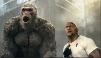  ?? WARNER BROS. VIA AP ?? This image released by Warner Bros. shows Dwayne Johnson in a scene from “Rampage.” Johnson’s arcade game-inspired “Rampage” crept past last week’s top film “A Quiet Place” to take the No. 1 spot on the box office charts.