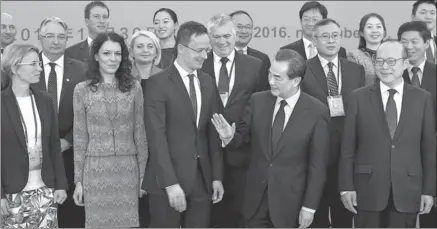  ?? WANG ZHUANGFEI / CHINA DAILY ?? Foreign Minister Wang Yi (second from right) gestures to his Hungarian counterpar­t Peter Szijjarto in the first meeting of the two countries’ work group on the Belt and Road Initiative in Beijing on Wednesday.