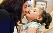  ?? THOMAS PEIPERT / AP ?? Meagan Patrick kisses her daughter, Addelyn Patrick, 5, at Realm of Caring in Colorado Springs, Colo. Meagan Patrick is among the parents using CBD to treat epilepsy symptoms in their children.