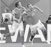  ?? [AP PHOTO] ?? Russia’s scorer Artyom Dzyuba, right, and Mario Fernandes celebrate a goal against Egypt at the World Cup on Tuesday in St. Petersburg, Russia.