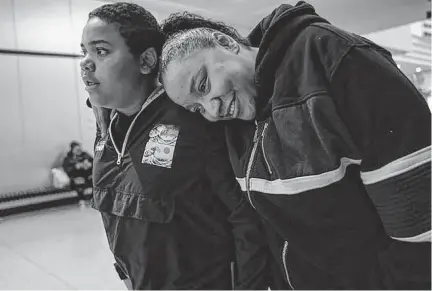  ?? ANGELINA KATSANIS TNS ?? Latasha Bacon leans on her son Davonte, 13, as they shop at Northtown Mall in Blaine, Minnesota, on April 19. When Davonte and his sister Layla Jackson were taken from Latasha by child protective services in 2018, they ended up with an abusive foster home.