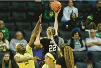  ?? THOMAS BOYD/AP ?? Stanford forward Cameron Brink (22) shoots over Oregon center Phillipina Kyei (15) during the Cardinal’s victory Saturday.