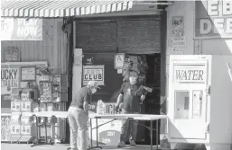  ?? DAMIAN DOVARGANES/AP 2020 ?? A customer purchases water in Los Angeles. An influx of federal funds from the latest virus relief bill may help some states improve drinking water.