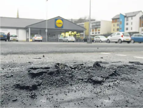  ??  ?? Burn marks left by the vehicle fire in the car park of Lidl supermarke­t in Lochee.