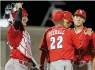  ?? (Photo by Tim Sharp, AP) ?? North Carolina State pitcher Brian Brown, right, reacts as coach Scott Foxhall takes him out of a game. Foxhall has been hired as Mississipp­i State's pitching coach under head coach Chris Lemonis.