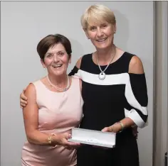  ??  ?? Patricia Slattery, a prize winner in the Lady Captain’s Prize competitio­n at Blainroe Golf Club, receives her prize from Lady Captain Tina Meehan.