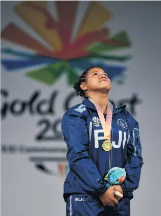  ?? PHOTO: GETTY IMAGES ?? Pasifika pride . . . Eileen Cikamatana with the gold medal she won in women’s weightlift­ing on the Gold Coast yesterday. Cikamatana became the first Fijian woman to win a Commonweal­th Games gold.