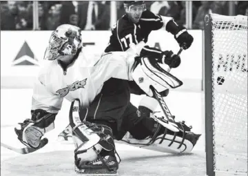  ?? Mark J. Terrill Associated Press ?? DUCKS GOALIE Jonas Hiller can’t stop a rebound by the Kings’ Jeff Carter (77) during the second period. Carter, playing his fourth game with the Kings, would add another goal later in the period.