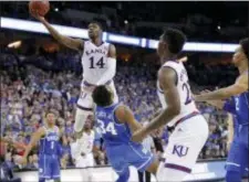  ?? CHARLIE NEIBERGALL — THE ASSOCIATED PRESS ?? Kansas’ Malik Newman (14) is fouled on his way to the basket by Duke’s Wendell Carter Jr (34) during overtime of a regional final game in the NCAA tournament Sunday in Omaha, Neb.