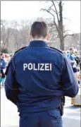  ?? CHRISTOPHE GATEAU/AFP ?? A German police officer patrols during the half-marathon in Berlin on Sunday.