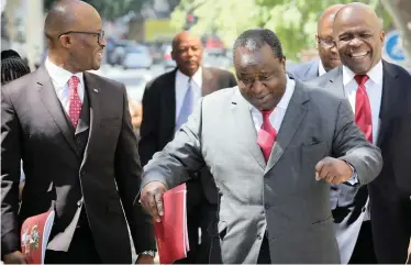  ?? | SUMAYA HISHAM | Reuters ?? FINANCE Minister Tito Mboweni does an impromptu jig as he arrives to deliver his Medium-Term Budget Policy statement at Parliament in Cape Town on Wednesday.