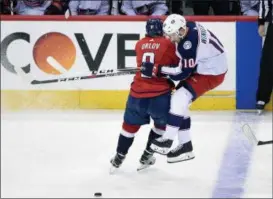  ?? NICK WASS — THE ASSOCIATED PRESS ?? Capitals defenseman Dmitry Orlov hits Blue Jackets center Alexander Wennberg during overtime April 21 in Washington. The Capitals won, 4-3.