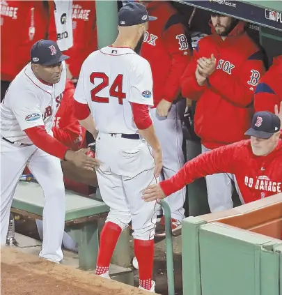  ?? STAFF PHOTO BY STUART CAHILL ?? JOB WELL DONE: David Price is greeted at the dugout after being pulled in the fifth inning of the Red Sox’ 7-5 win against the Houston Astros in Game 2 of the ALCS last night at Fenway Park.