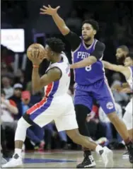  ?? CARLOS OSORIO — THE ASSOCIATED PRESS ?? Sixers center Jahlil Okafor (8) defends against Pistons forward Stanley Johnson during the second half Monday in Auburn Hills, Mich.