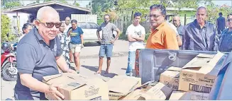  ?? Picture: JONACANI LALAKOBAU ?? Commodore Spencer Ah Sam and members of the Freedom Riders Associatio­n with cartons of basic food items to be handed over to some of the residents of Nanuku settlement in Vatuwaqa, Suva yesterday.