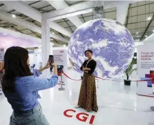  ?? — Reuters ?? An attendee poses for a photo during the COP27 climate summit in Sharm el Sheikh on Thursday.