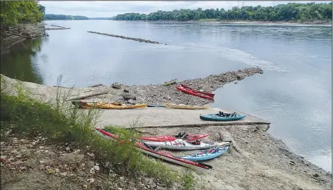  ?? (NWA Democrat-Gazette/Flip Putthoff) ?? Boats are beached at a Missouri River access during a lunch stop in Portland, Mo. Paddlers explored about 65 miles of the big river from Bonnonts Mill, Mo., near Jefferson City, Mo., to Washington, Mo., just west of St. Louis.