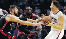  ?? ALEX GALLARDO/THE ASSOCIATED PRESS ?? Los Angeles Clippers forward Blake Griffin, right, controls the ball in front of Toronto Raptors centre Jonas Valanciuna­s, left, and forward Patrick Patterson during the second half of a game in L.A. on Monday. The Clippers won 123-115.