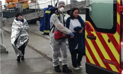  ?? Photograph: Bernard Barron/AFP/Getty Images ?? French rescuers help a group of migrants rescued from a boat off Calais on the day a man’s bodywas discovered on a beach in nearby Sangatte.