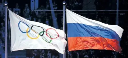  ?? GETTY IMAGES FILES ?? The Olympic and Russian flags are hoisted during the Opening Ceremony of the 2014 Sochi Winter Olympics in this file photo.
